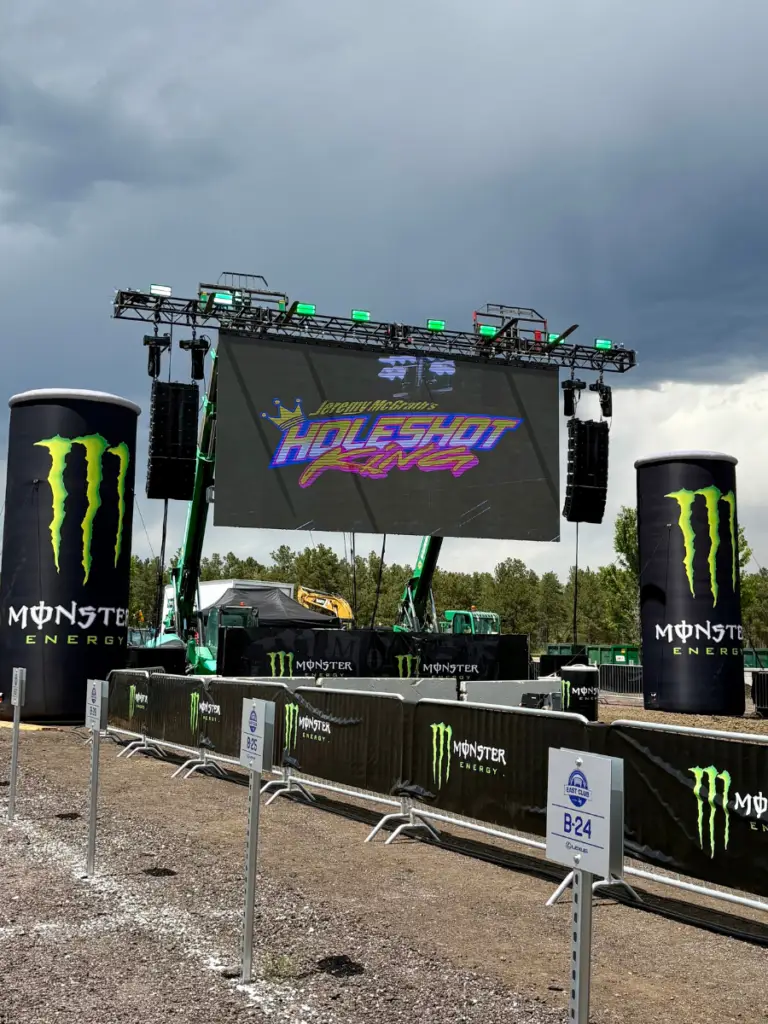 Modular LED wall rental installed for a live outdoor motorsports event with large format display, stage rigging, and branding.