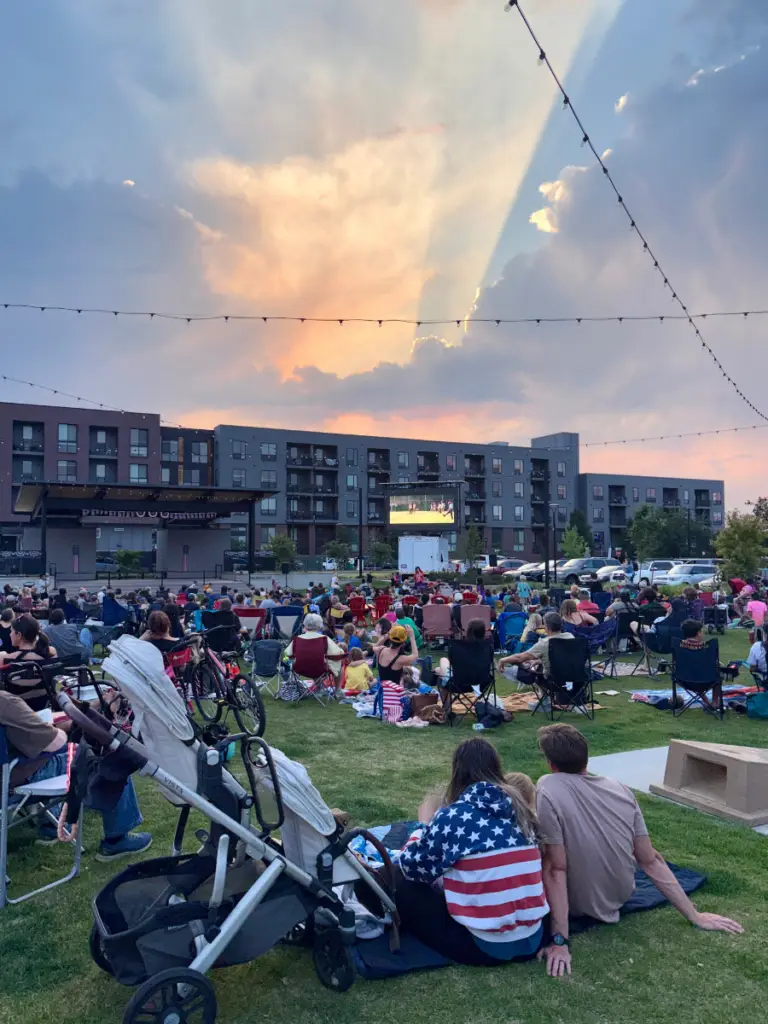 Mobile LED screen rental supporting an outdoor community movie night with attendees gathered on a lawn for a large scale public viewing event.