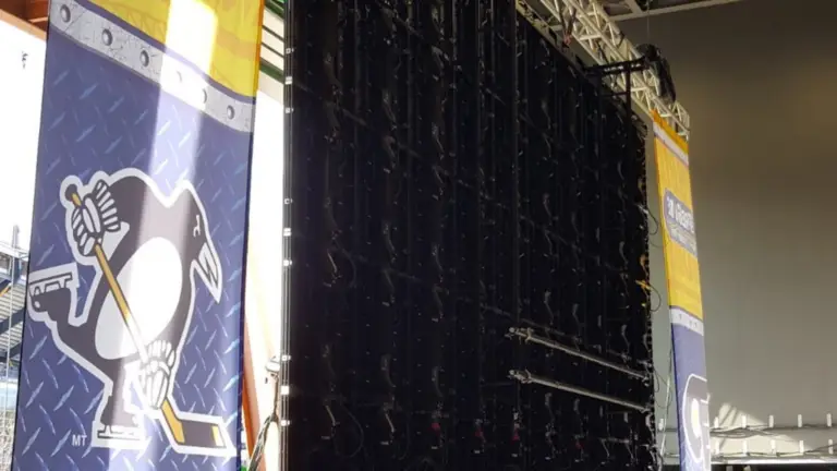 Rear view of a suspended modular LED wall showing custom rigging and installation for a large-scale event.