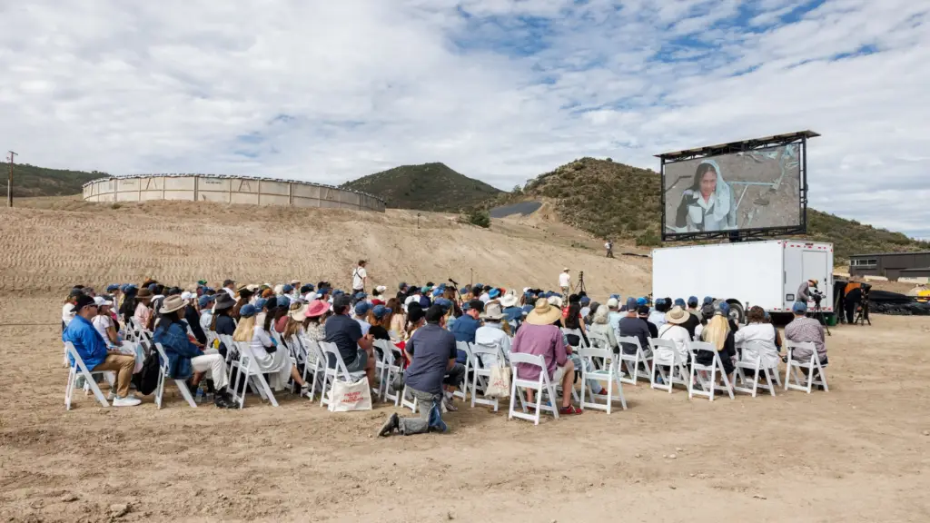 Large outdoor audience watching performative art on a mobile LED screen during the Aspen AIR Festival art installation.