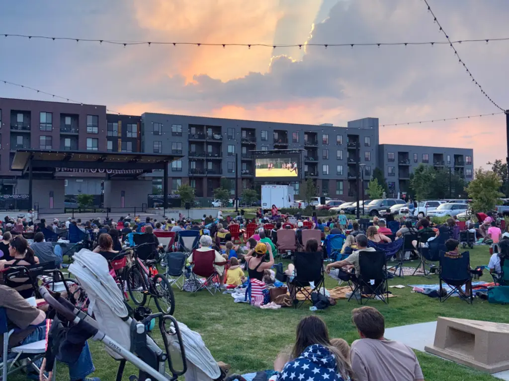 Mobile LED screen rental supporting an outdoor community movie night with attendees gathered on a lawn for a large scale public viewing event.