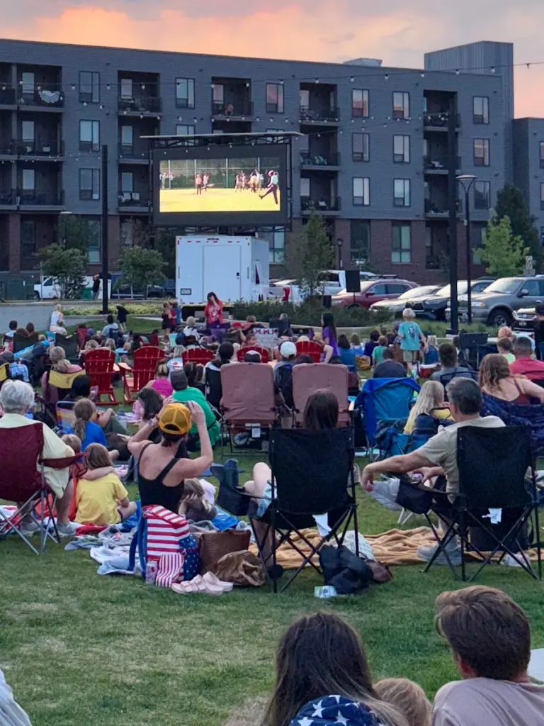Mobile LED screen rental supporting an outdoor community movie night with attendees gathered on a lawn for a large scale public viewing event.