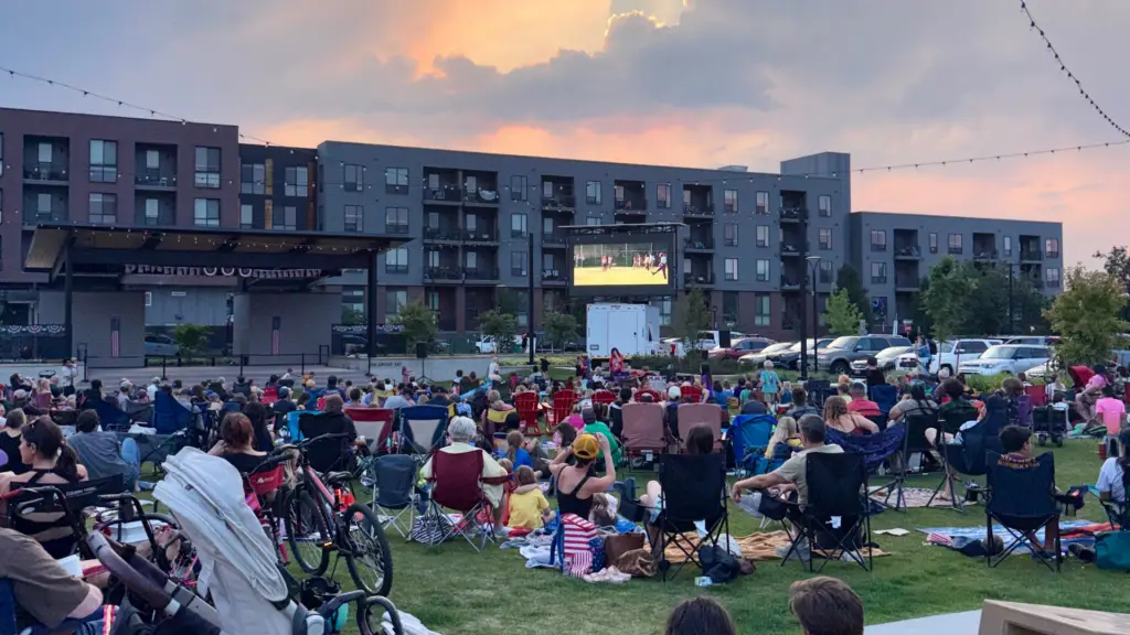 Mobile LED screen rental supporting an outdoor community movie night with attendees gathered on a lawn for a large scale public viewing event.