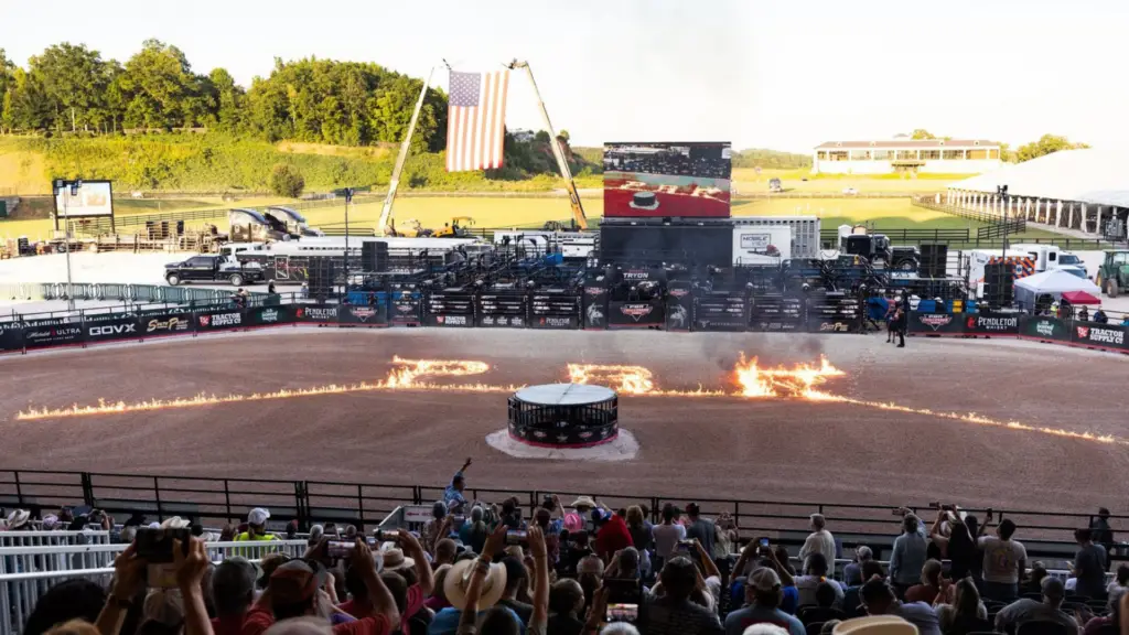 Mobile LED trailer displaying live event coverage at a large outdoor rodeo arena with thousands of spectators.