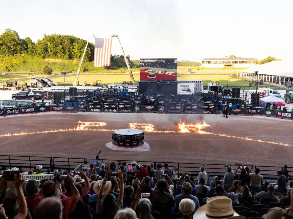 Mobile LED trailer displaying live event coverage at a large outdoor rodeo arena with thousands of spectators.