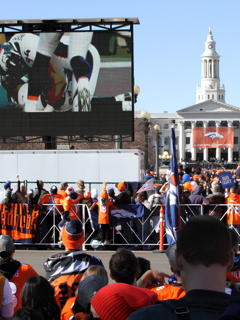 Mobile LED trailer displaying Denver Broncos game coverage at a tailgate event on the Colorado State Capitol grounds in Denver.
